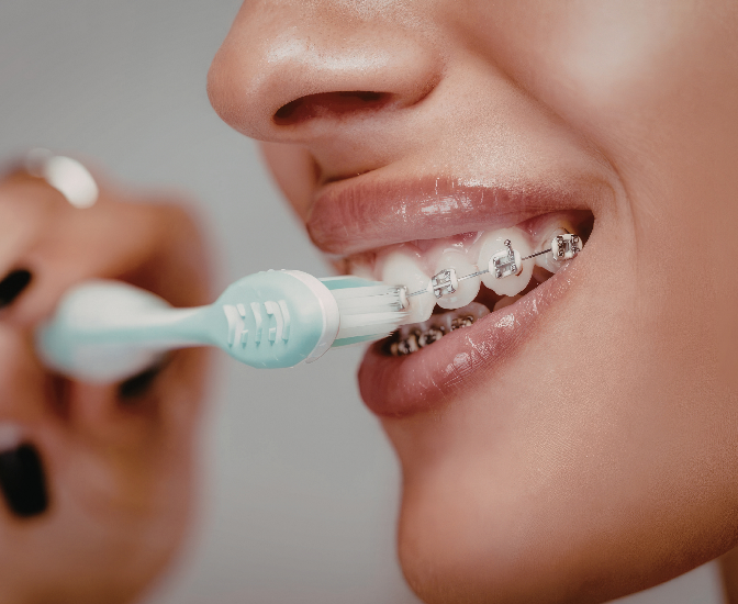 A young child practicing daily dental hygiene by brushing their teeth correctly, a routine supported by the specialists at PDG Dental.